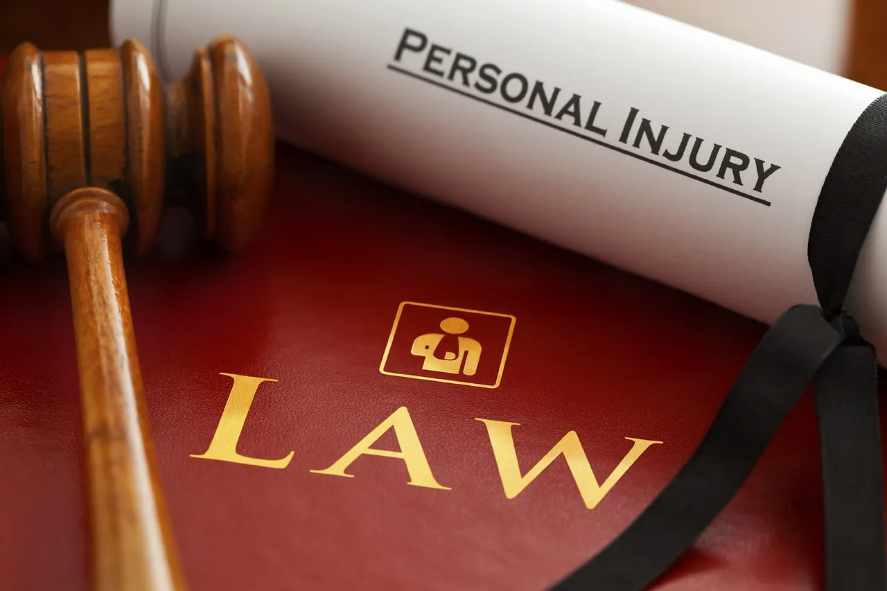 Personal injury lawsuit document and gavel on a law book.