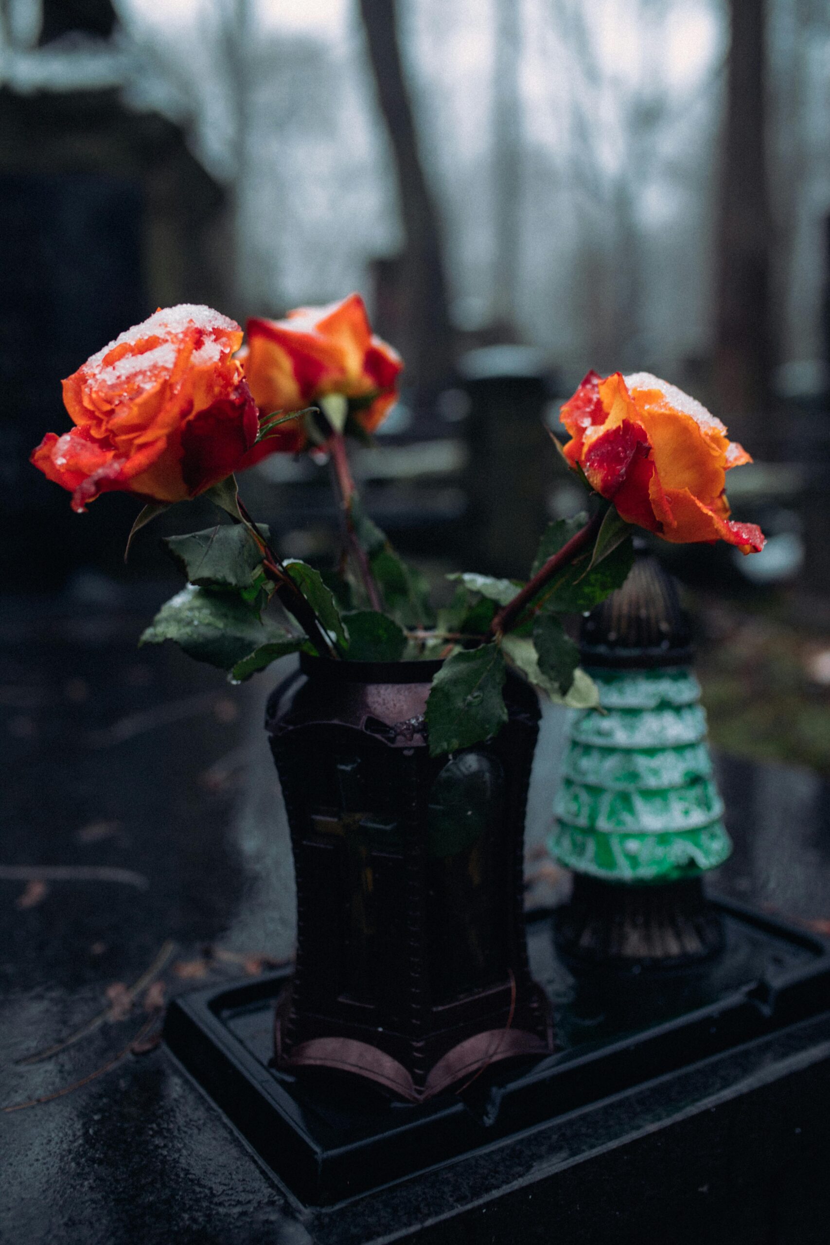 Flowers in the snow at a grave, symbolizing the enduring remembrance of a loved one lost to wrongful death.