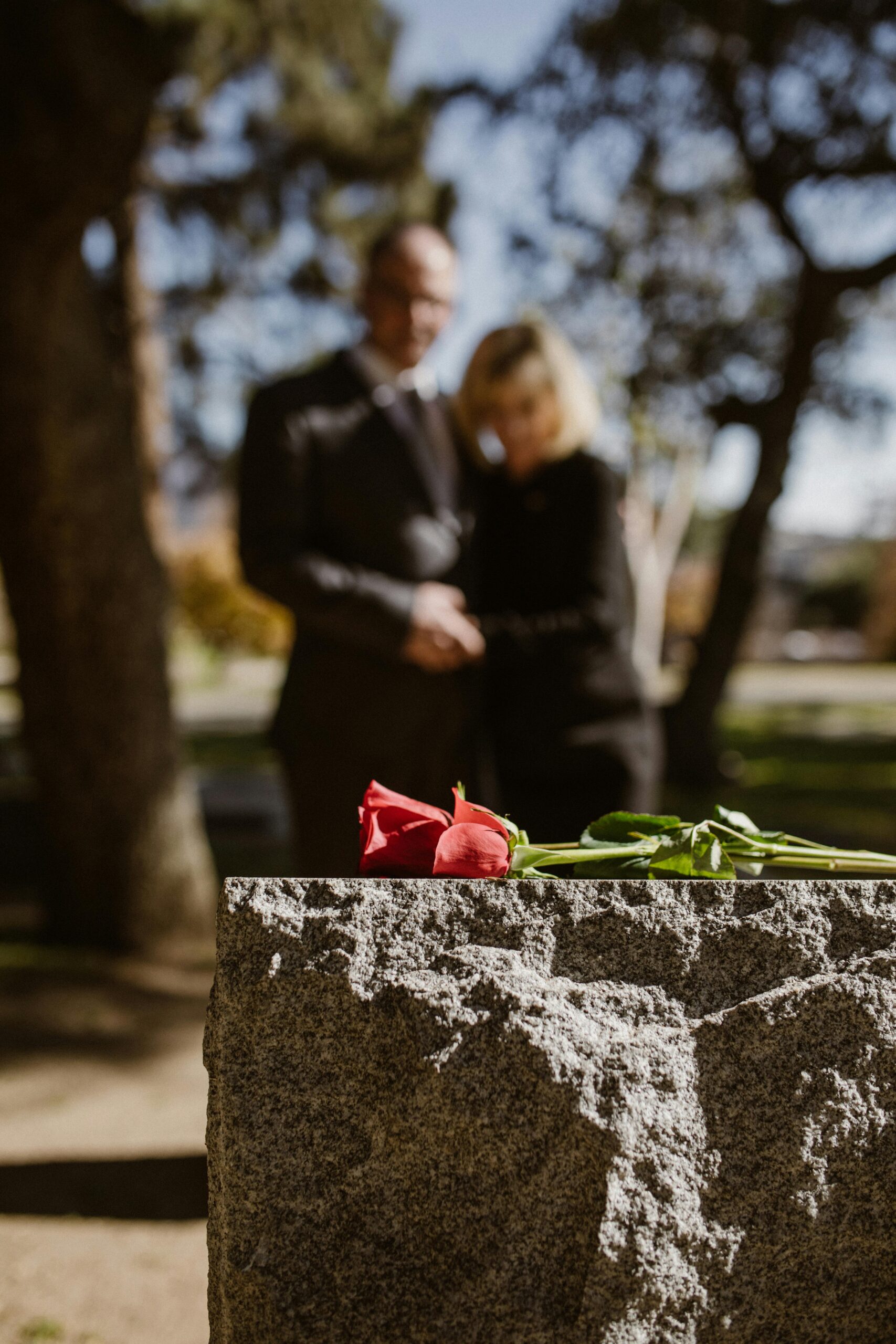 A solemn moment at a gravesite, symbolizing the grief and loss experienced after a wrongful death.