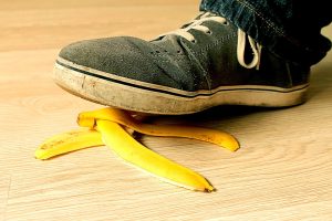 A shoe slipping on a banana peel representing a slip and fall accident.