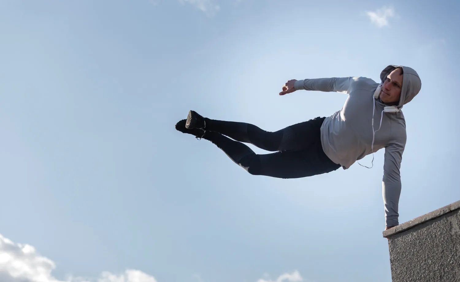 Person mid-air during parkour, demonstrating potential fall risks