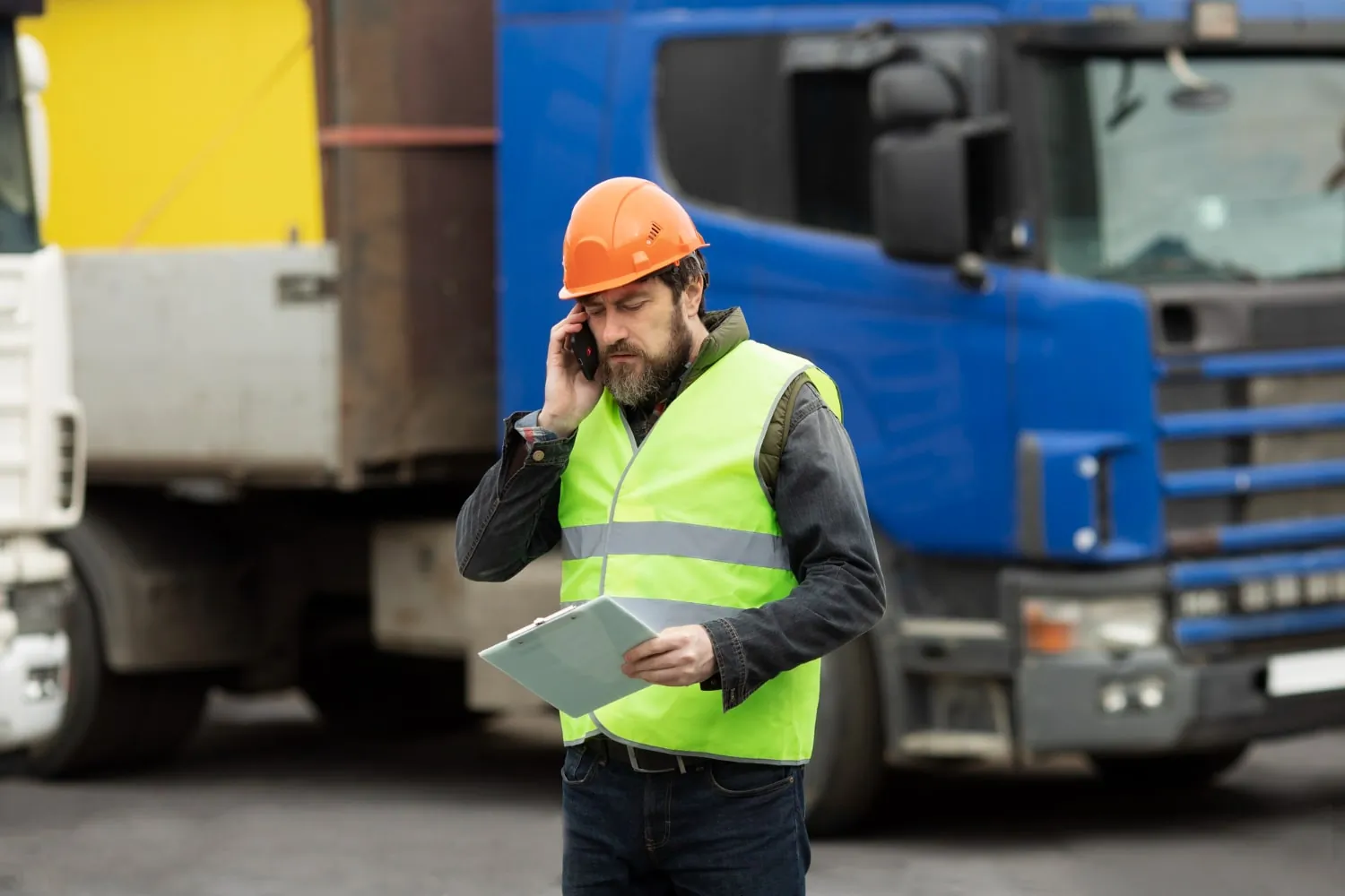 Truck manager on phone discussing driver accident after a collision