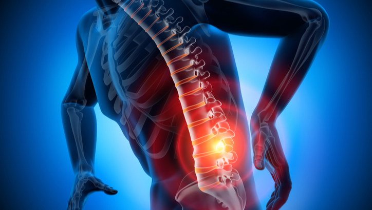 Digital illustration of a person holding their lower back, with the spine highlighted and a red glow indicating pain or injury in the lumbar region.