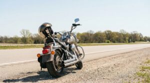 cruiser motorcycle with helmet resting on seat parked along open highway
