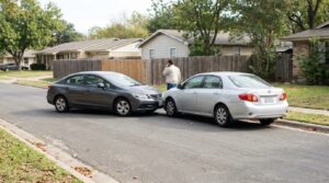 two sedans involved in rear-end collision on residential street with person on phone