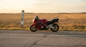 sport motorcycle parked on rural roadside beside weathered mile marker post